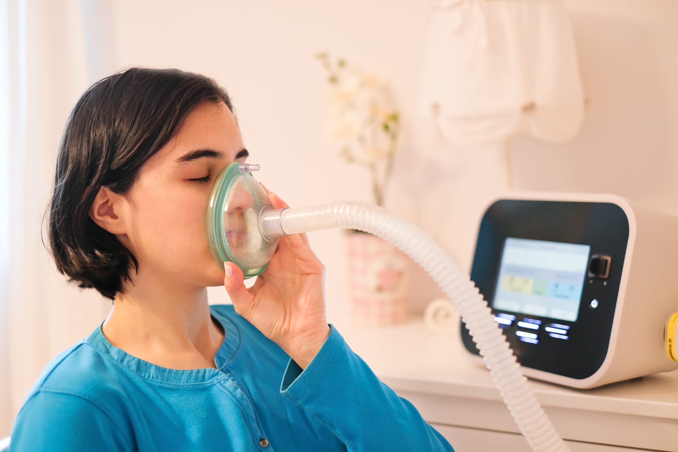 Patient receiving respiratory therapy at home